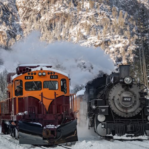 Diesel and steam locomotive in the Colorado winter